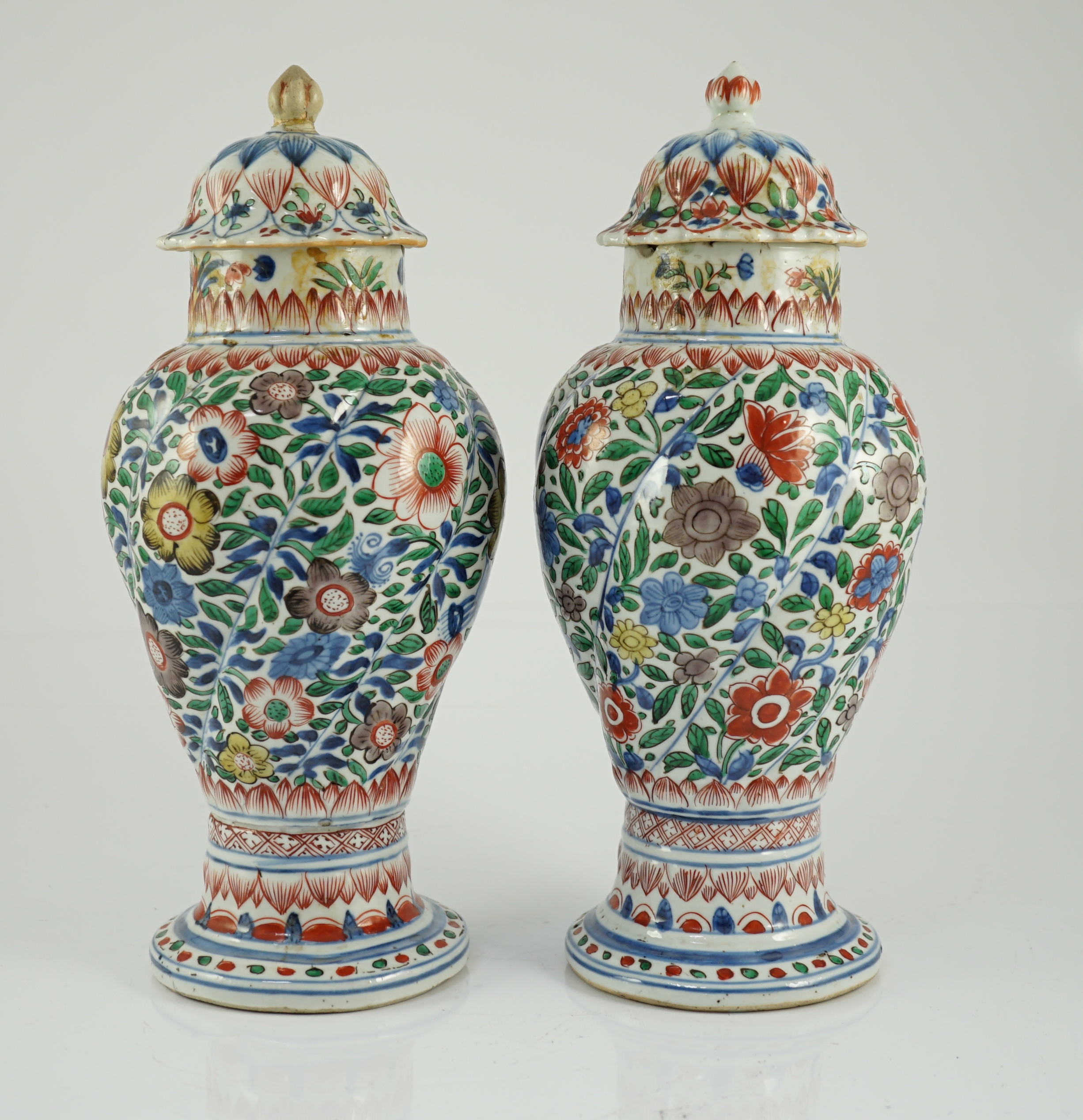 A pair of Chinese wucai spiral lobed baluster vases and covers, Kangxi, c.1680